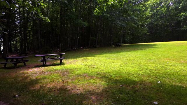 Empty picnic benches on lawn at Wolfneck State Park, Maine