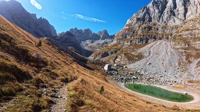 Hiking the iconic Peaks of the Balkans trail. Experience breathtaking mountain views and narrow pathways across Albania, Kosovo, and Montenegro.