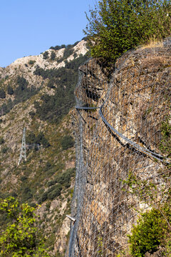 Steel mesh protecting a rocky slope against rockfalls and landslides