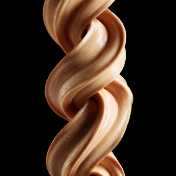 Chocolate protein cream swirl in glossy isolated on black background with clipping path, concept of sweetness and dessert appeal