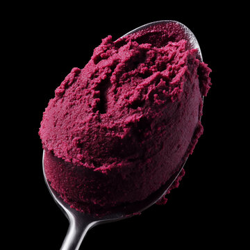 Closeup of berry sorbet on spoon isolated on black background with clipping path, concept of freshness and dessert enjoyment