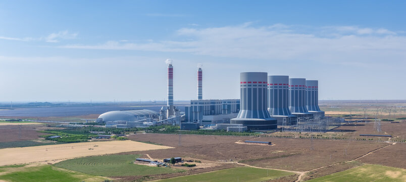Close-Up Aerial of Ultra-Supercritical Thermal Power Plant Amid Farmland Under Blue Sky