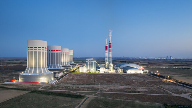 Modern Coal-Fired Power Plant with Cooling Towers and Chimneys at Blue Hour﻿