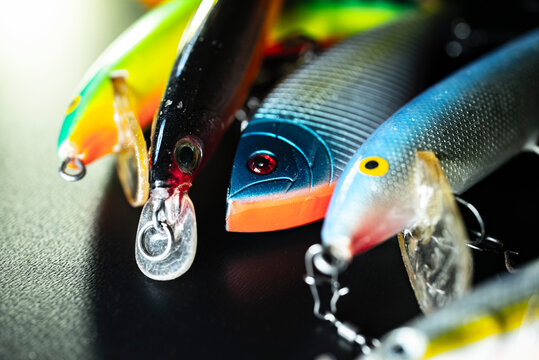 Colorful artificial fishing lures on a black background The Concept of sport fishing