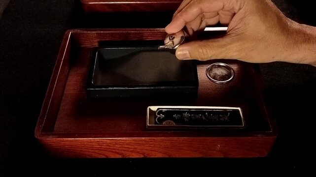 The traditional Far East Asian method of grinding ink sticks on a stone creates a moment of peace and relaxation before used it for writing or painting.