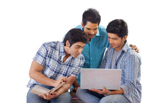 Three friends studying using laptop