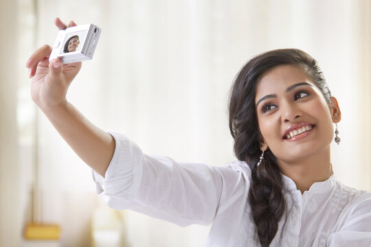 Young woman taking self photo with camera