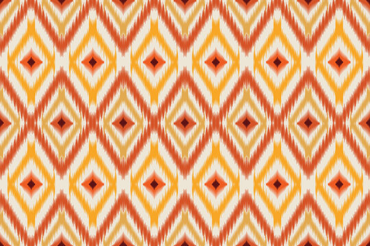 Seamless ikat pattern background in warm ethnic style. Geometric diamond motifs with blurry zig-zag edges, featuring a palette of orange, yellow, terracotta red, and cream background. 