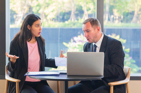 Businessman having argument with businesswomen  on table in office. business people conflict working problem.