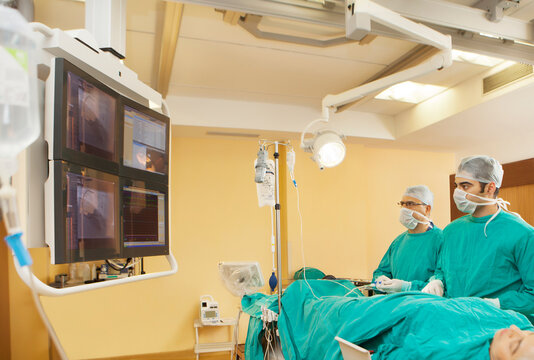 Surgeons monitoring patient on screen