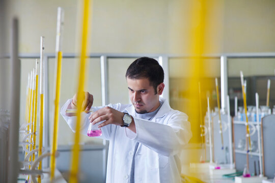 Student pouring liquid into beaker