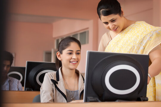 Teacher assisting student in classroom