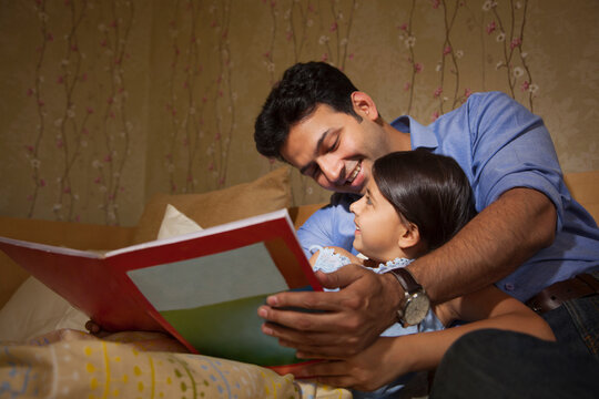 Father reading a story to his daughter