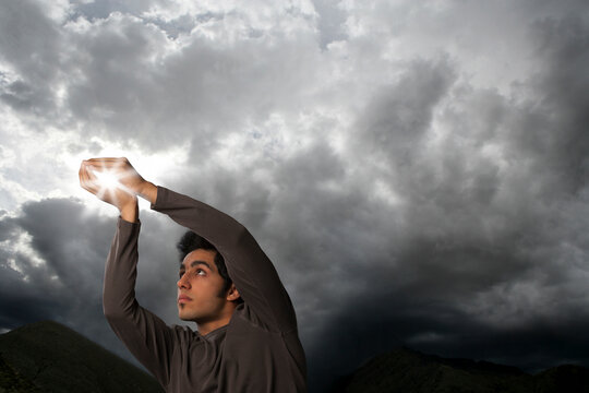 Man trying to catch sun rays