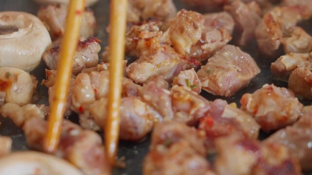 The marinated mutton pieces are continuously grilled and steaming