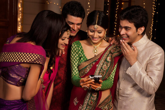 Friends looking at a picture on a camera