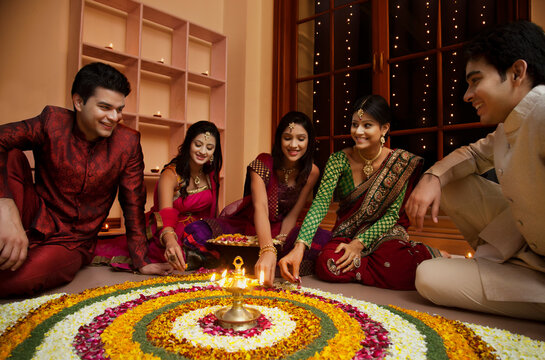 Friends making a rangoli