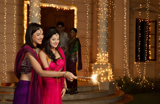 Women playing with sparklers