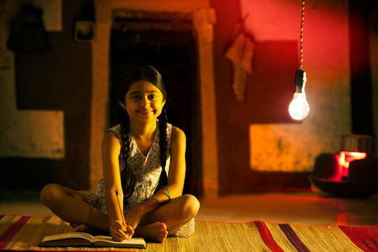 Portrait of rural girl studying at night