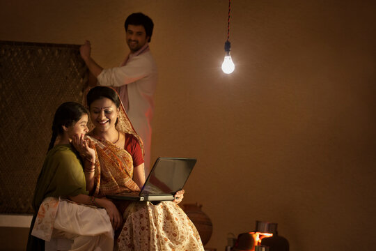 Rural mother and daughter with laptop