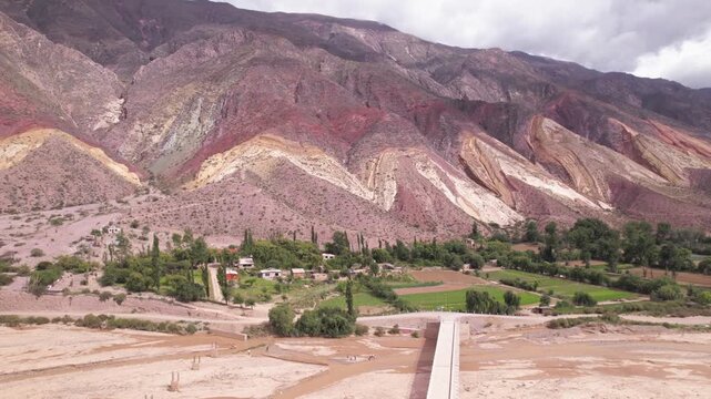 4K drone aerial view of Paleta del Pintor in Maimar&aacute;, Jujuy, Argentina. Iconic colorful mountain landscape in the Quebrada de Humahuaca, with vibrant geological layers shaped by erosion.