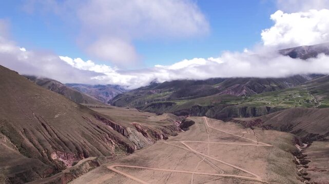 4K drone aerial view of the winding mountain road to Iruya, Jujuy, Argentina. Scenic zigzag route crossing the Andes with dramatic landscapes and remote valleys.