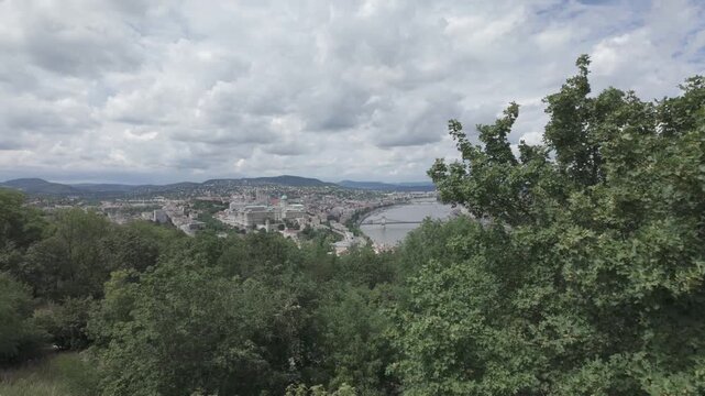 4K video shot from Gellert Hill in Budapest, Hungary showing partial River Danube with a bridge and Buda Castle in a distance.