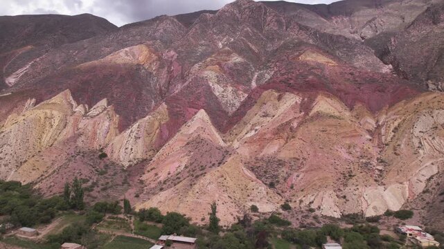 4K drone aerial view of Paleta del Pintor in Maimar&aacute;, Jujuy, Argentina. Iconic colorful mountain landscape in the Quebrada de Humahuaca, with vibrant geological layers shaped by erosion.