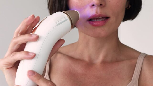 Close-Up of Female Using Innovative IPL Laser Device for Facial Hair Removal and Smooth Upper Lip Skin Care