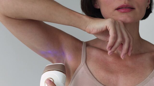Cropped View of Female Using Modern IPL Laser Hair Removal Device for Axillary Epilation and Smooth Underarm Skin Care