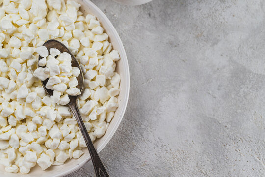 Rustic cottage cheese in a plate on the table