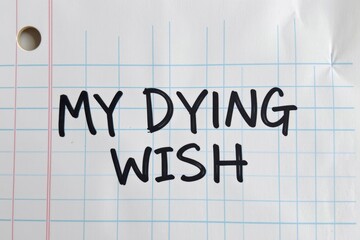 Handwritten text reads "MY DYING WISH" on lined paper © kornc