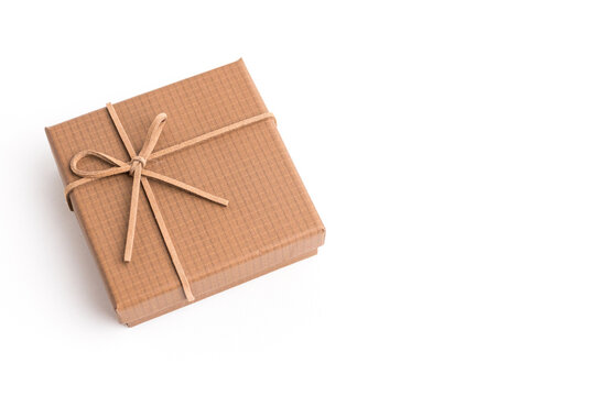 Small brown kraft paper gift box tied with thin string isolated on white background