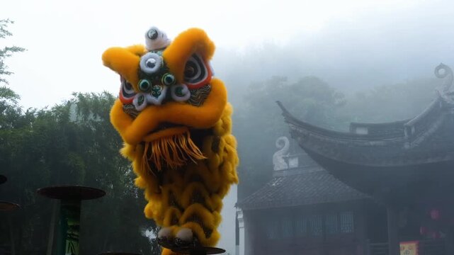 Yellow lion dance in misty temple courtyard