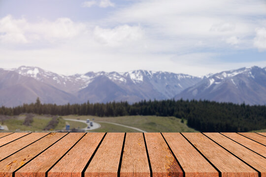 blur beautiful snow mountain peak with glacier landscape background with perspective wood table top for show and promote goods,product on retail display concept