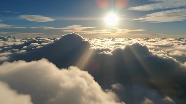 Sun shining through fluffy white clouds in a blue sky