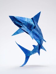 Fototapeta premium Blue Origami Shark Figure Made Of Folded Paper Isolated On A White Background