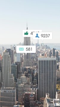 Animation of changing numbers, icons in notification bars over aerial view of modern cityscape