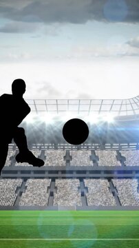 Animation of silhouette of football player kicking ball over sports stadium