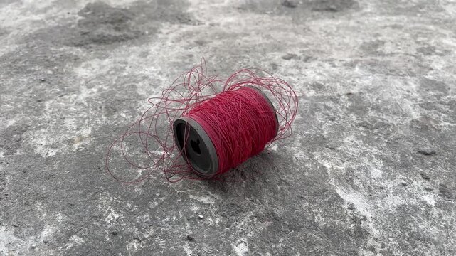 Spool of red kite string for traditional wind games