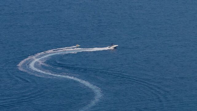 Fast motorboat speeding across deep blue coastal waters