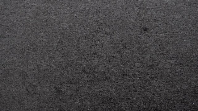 Black paper texture background with rough fiber surface and dark grey cardboard pattern