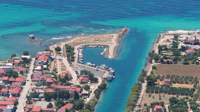 Turquoise canal linking a marina and open sea
