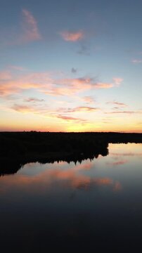 Beautiful sunset with clouds over a lake in insta format