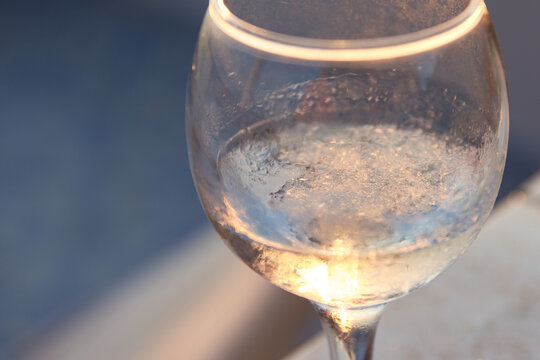 Close-up of a chilled glass filled with traditional Greek ouzo and ice cubes