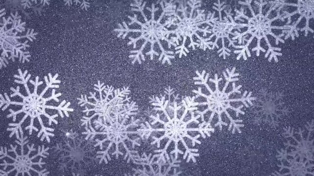 Glittering silver snowflakes falling on sparkling winter holiday background