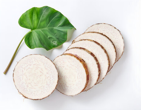 Taro vegetable slices with green leaf on white background