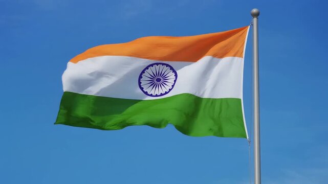 National Flag of India Waving on Flagpole Against Clear Blue Sky