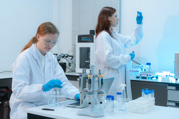 researcher testing water purity looking through microscope monitor soil moisture and crop health in...