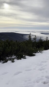 Scenic winter mountain view from Koz&iacute; hřbety above &Scaron;pindlerův Ml&yacute;n in the Krkono&scaron;e Mountains, Czech Republic. Snow-covered mountain slopes and ridges create a beautiful panoramic view. 